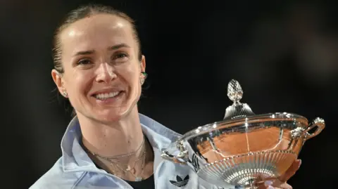 Ukraine's Elina Svitolina holds the trophy after winning the Italian Open final