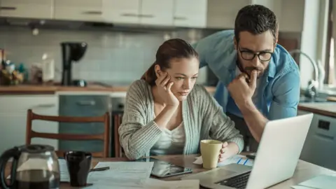 Getty Images Stock image of couple looking at laptop