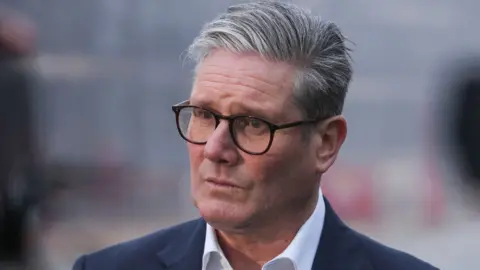 Getty Images Keir Starmer looks off to the side of the shot - he has grey hair and glasses and is wearing a dark suit and white shirt