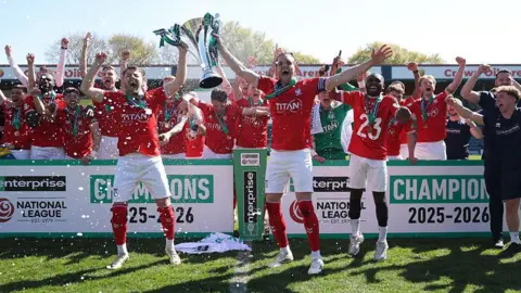 Ollie Pearce and Callum Howe of York City lift the National League Trophy after the 1-1 draw at Rochdale