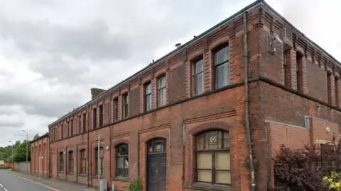 A redbrick industrial building formerly in use as a sawmill.