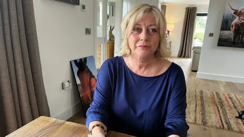 Crispin Rolfe / BBC Sheena Fryer sat at a table