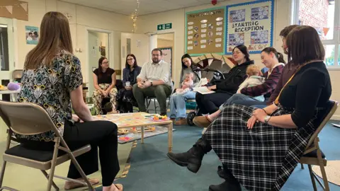 BBC/PHIL BODMER Young parents in a group discussion about the importance of healthy eating for their babies