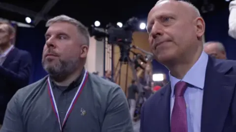 BBC The BBC's Ben Tavener and Steve Rosenberg are seen in a close-up shot at Vladimir Putin's end of 2025 press conference.
