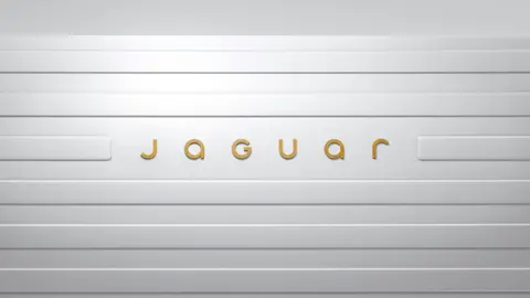 The new Jaguar logo in gold lettering, placed on a white background