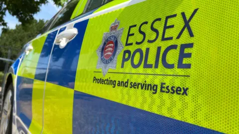 Side view of police car with the Essex force signage and logo.