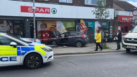 Car with its bonnet up having crashed into a post box on Gorleston high street