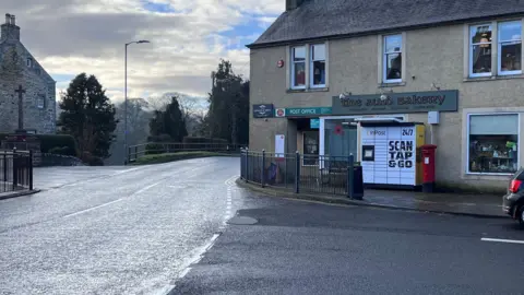 A road junction with a building in the background