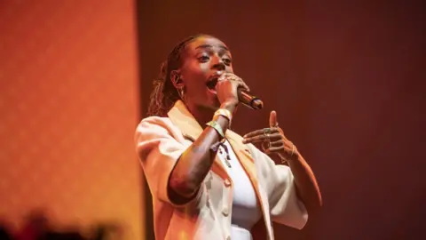 Cat Burns performing on the Woodsies at Glastonbury Festival 2023