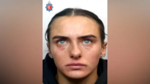 Police provided headshot of Megan Murphy who has her hair tied back and is wearing dark clothing.