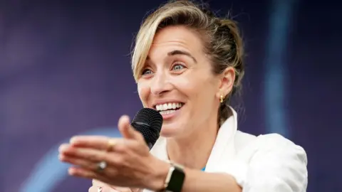 PA Media Vicky McClure is pictured with a microphone in hand