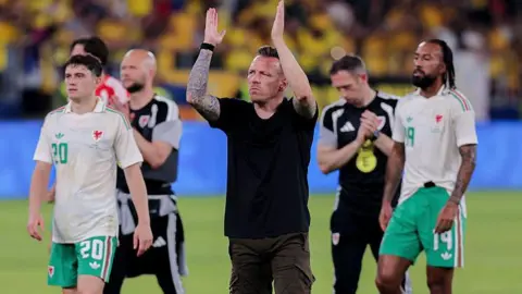 Wales boss Craig Bellamy applauds