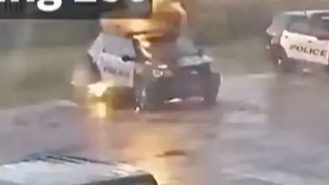 A police car hit by lightning.