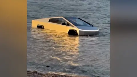 A Tesla half-submerged in water