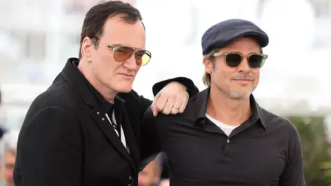 Getty Images uentin Tarantino and Brad Pitt attend the photocall for "Once Upon A Time In Hollywood" during the 72nd annual Cannes Film Festival on May 22, 2019 in Cannes, France.