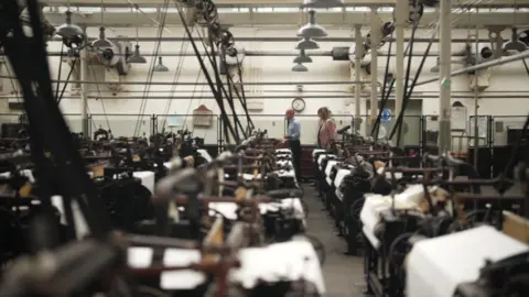 Empty spinning machines in a cotton mill museum.