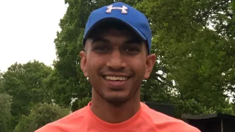 A young man in a baseball cap