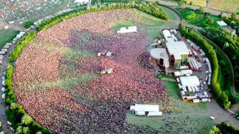 An aerial view of a huge crowd filling the circular bowl-shaped arena at Milton Keynes National Bowl 