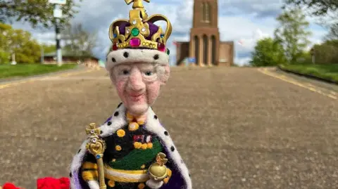 Andy Newbold A postbox topper of King Charles III in front of Guildford Cathedral