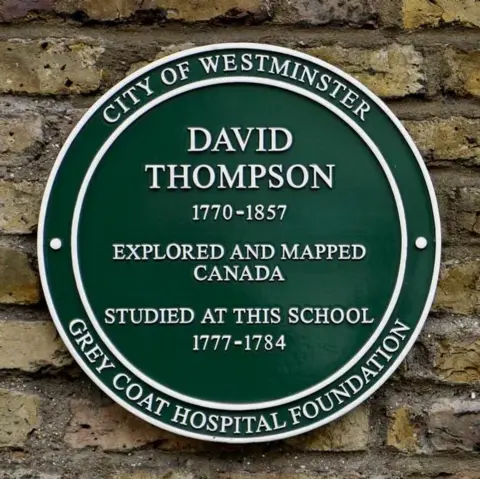 Grey Coat Hospital Foundation A green plaque on the wall of Grey Coat school. The white writing reads : "David Thompson, 1770-1857, Explored and mapped Canada, Studied at this school,
1777-1784. Grey Coat Hospital Foundation" It was unveiled in 2009 by explorer and TV personality Ray Mears.