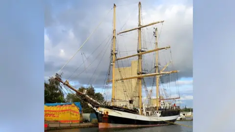 The Pelican of London at Sharpness boat which includes sails.