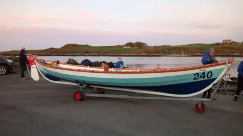 Boat being pushed on a wheel trailer at dawn