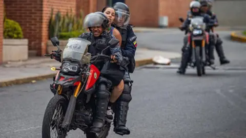 EPA Members of the Bolivarian National Guard (GNB) detain two people during protests over the results of the presidential elections in Caracas, Venezuela, 29 July 2024