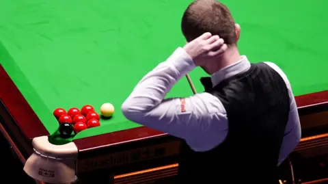 Mark Allen scratches his head