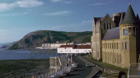Getty Images A general view of Old College, a tall brick building overlooking a bay.