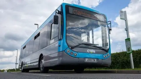 CT4N A low angle shot of a blue single decker bus with a grey trim.