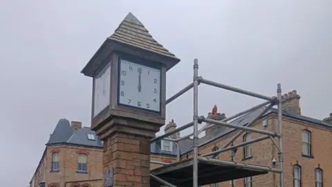 The restored Saltburn clock is looking new with scaffolding standing next to the structure to allow workers access to the clock.