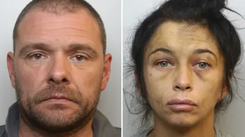 Avon and Somerset Police mug shot of Jamie Easterbrook and Elly-Jayne Cox. Jamie Easterbrook is on the left. He has short brown hair and facial hair. He is looking directly at the camera with a blank expression on his face. Elly-Jayne Cox is on the right. She has long dark hair tied in a bun. She is looking directly at the camera with a blank expression on her face.