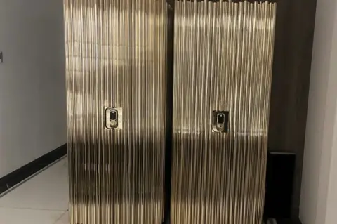 two full-length safes, golden in colour