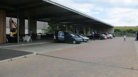 Several cars pictured in bays at Bridport's household recycling centre.