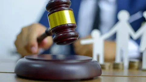 Getty Images A hand brings down a judge's gavel 