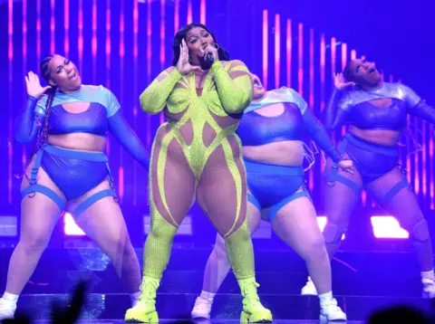 Getty Images Lizzo performs on stage with several dancers - none of whom are thought to be part of the current lawsuit