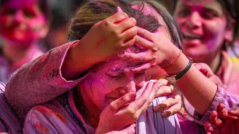 Getty images young women saw color on a friend's face