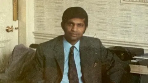 Rotherham NHS Foundation Trust Dr Mondal, appearing to be in his late 30s or early 40s, in a dark blazer and tie with light blue shirt.