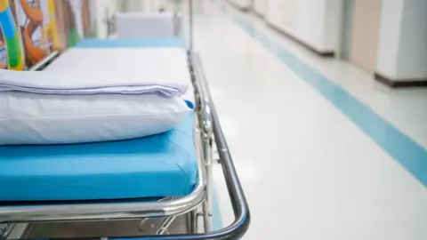 A hospital bed in a corridor