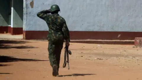 AFP via Getty Images) An armed soldier guarding a compound 