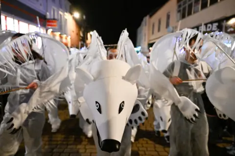 Stuart Walker People dressed as polar bears walk through Dumfries high street