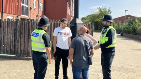 Shariqua Ahmed/BBC Police officers talk to members of the public