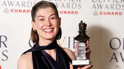 PA Media Rosamund Pike with her Best Actress award for Inter Alia at The Olivier Awards at the Royal Albert Hall, London