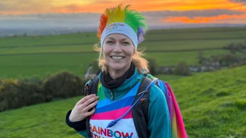 Polly Hatchard pictured in the countryside wearing a Rainbow Trust t-shirt