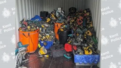 Kent Police A pile of power tools in what looks like a shipping container