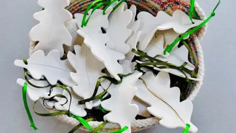 Ruth Gibson Oak leaves cut from rolled procelain with green ribbons