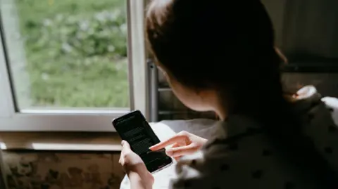 Getty Images A young girl using a phone