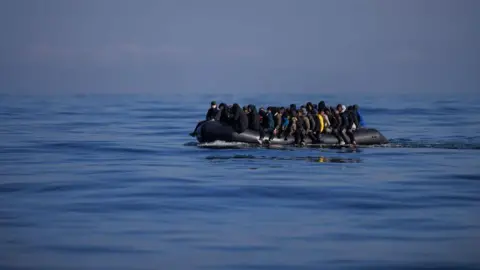 Getty Images People cross the English Channel in an inflatable dinghy in March 2024