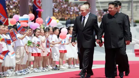 Sputnik / Getty Images In this pool photograph distributed by the Russian state agency Sputnik, people release balloons in the air as Russia's President Vladimir Putin and North Korea's leader Kim Jong Un attend a welcoming ceremony at Kim Il Sung Square in Pyongyang on June 19, 2024.
