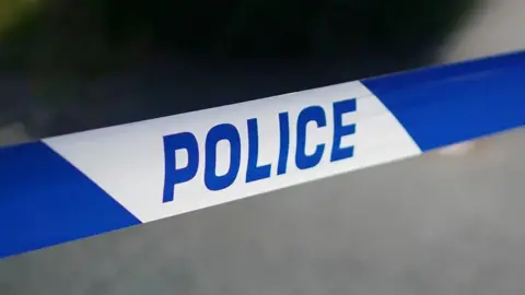A close up image of blue and white tape with the word police written on it